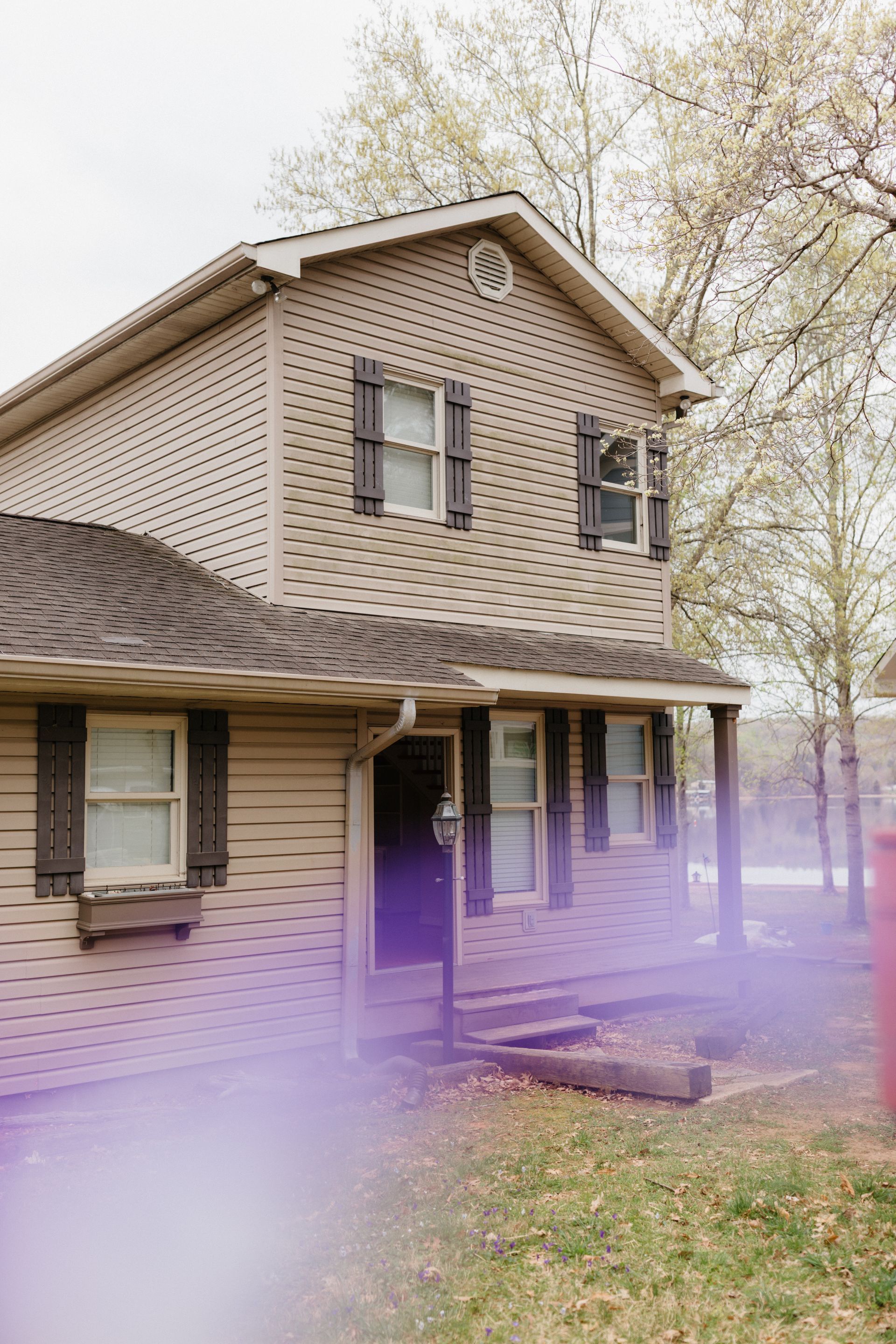 A house with purple smoke coming out of the front door.