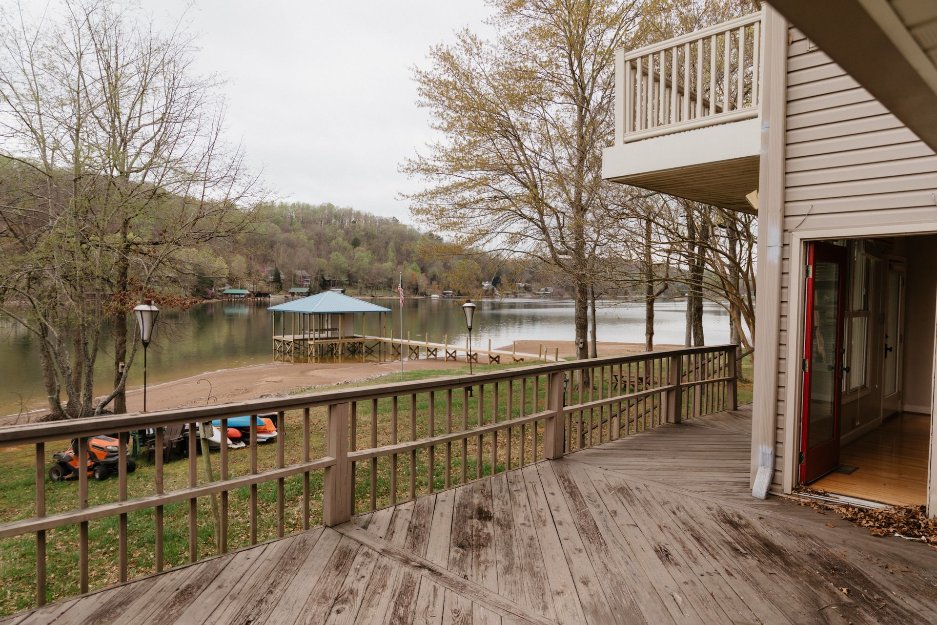 A house with a large deck overlooking a lake