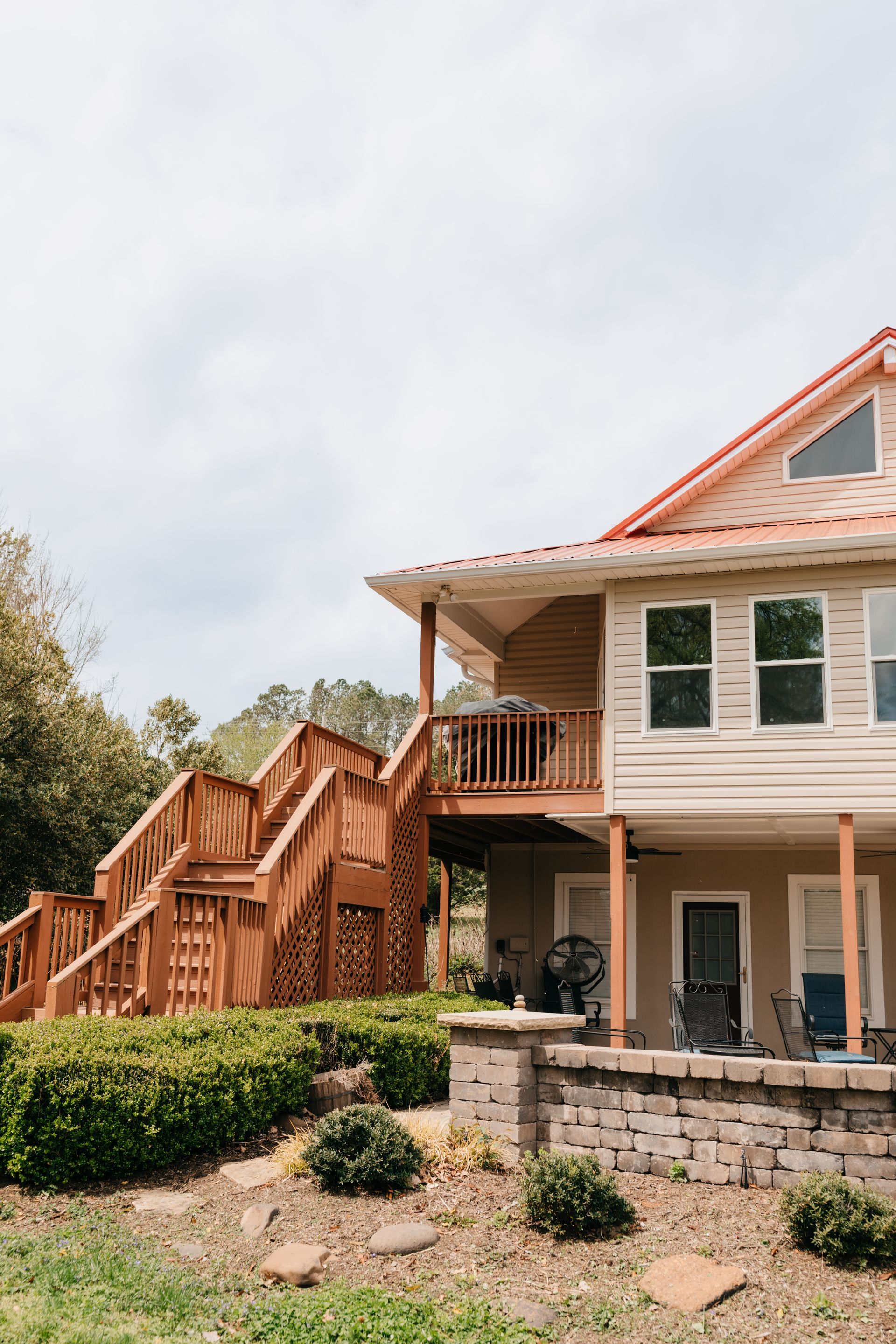 A large house with a large deck and stairs.