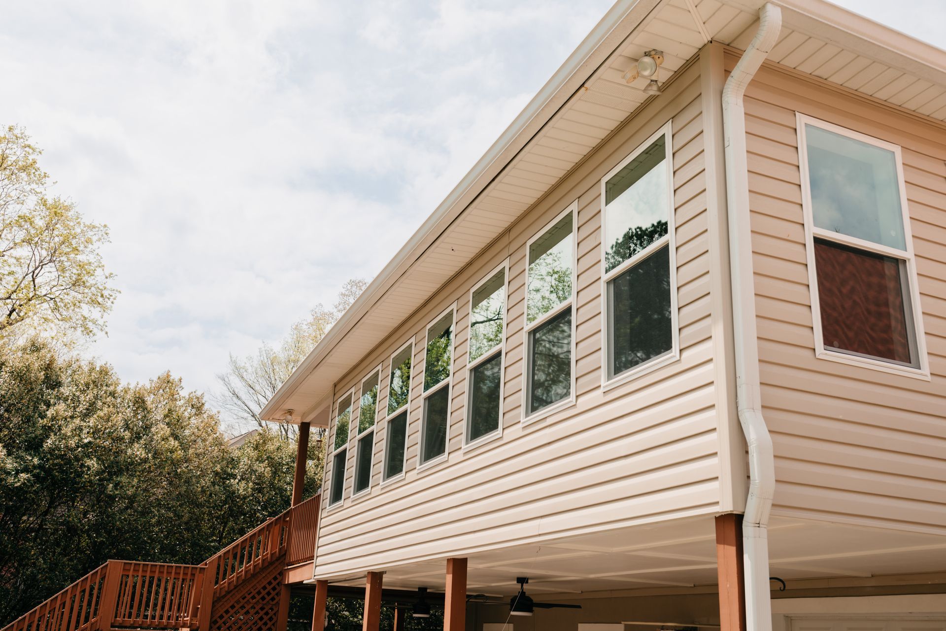 A large house with a lot of windows and a deck.