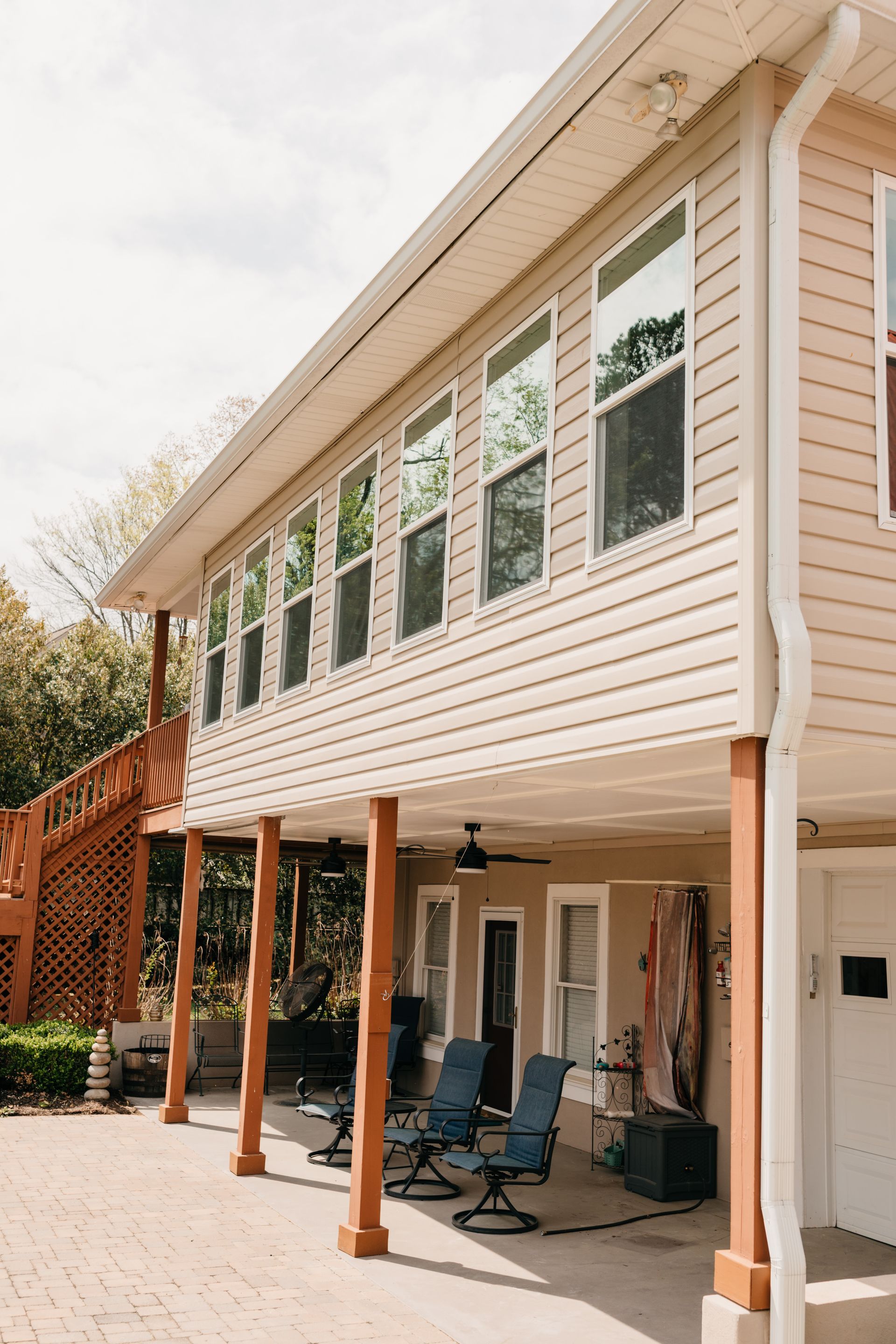 A large house with a large porch and a lot of windows.