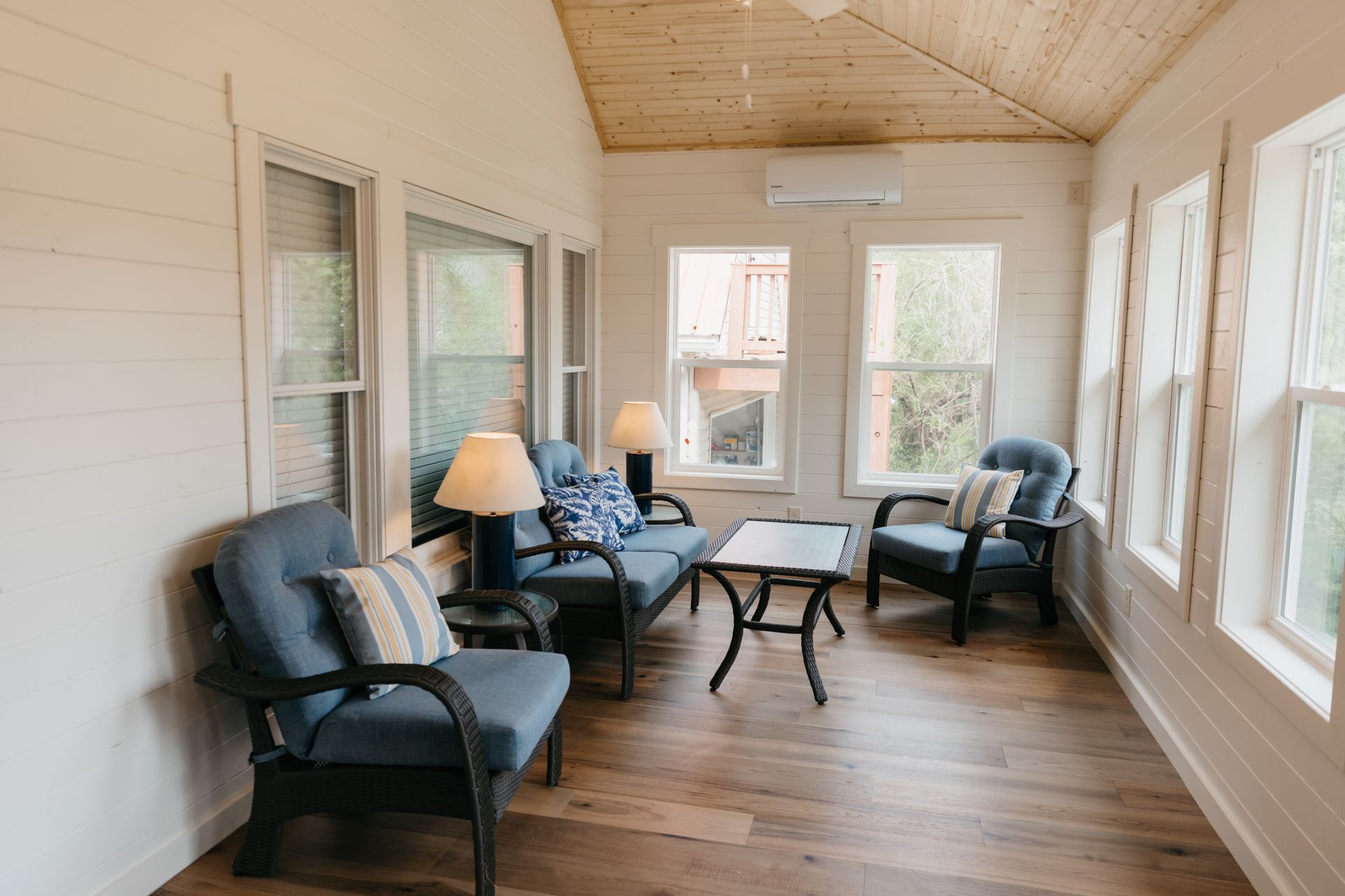 A living room filled with furniture and lots of windows.