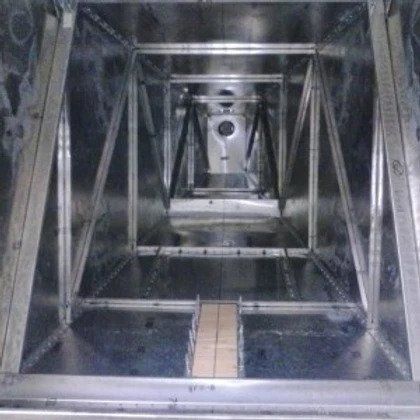 The inside of a metal box with a hole in the middle