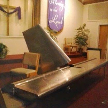 A church with a banner that says worthy is the lamb