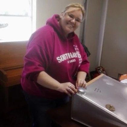 A woman wearing a pink sweatshirt that says southwave