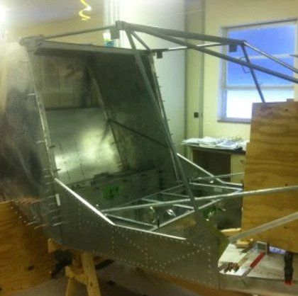 A piece of metal is sitting on a wooden table in a room