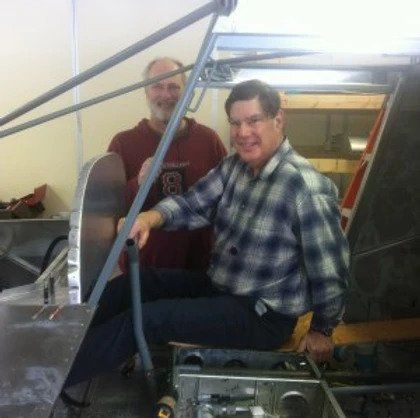 A man in a plaid shirt has the number 8 on his shirt