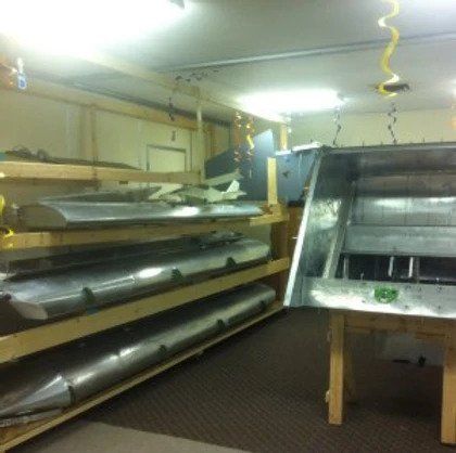 A room with a lot of metal objects on shelves