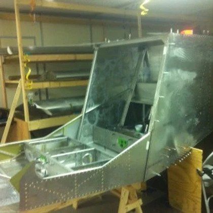 A piece of metal is sitting on a wooden table in a room.