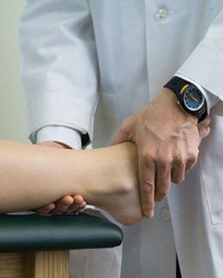 doctor checking a patient with ankle pain