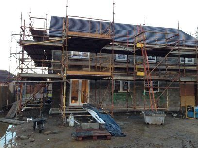 A house is being built with scaffolding around it.