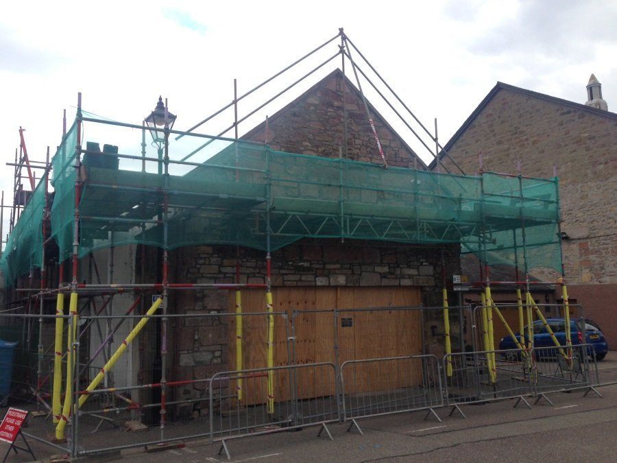 A building under construction with scaffolding around it