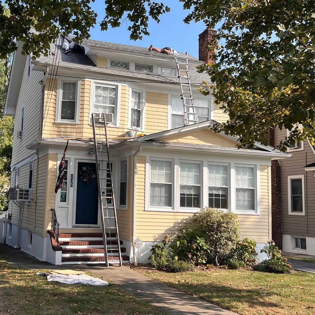 A yellow house with a ladder in front of it