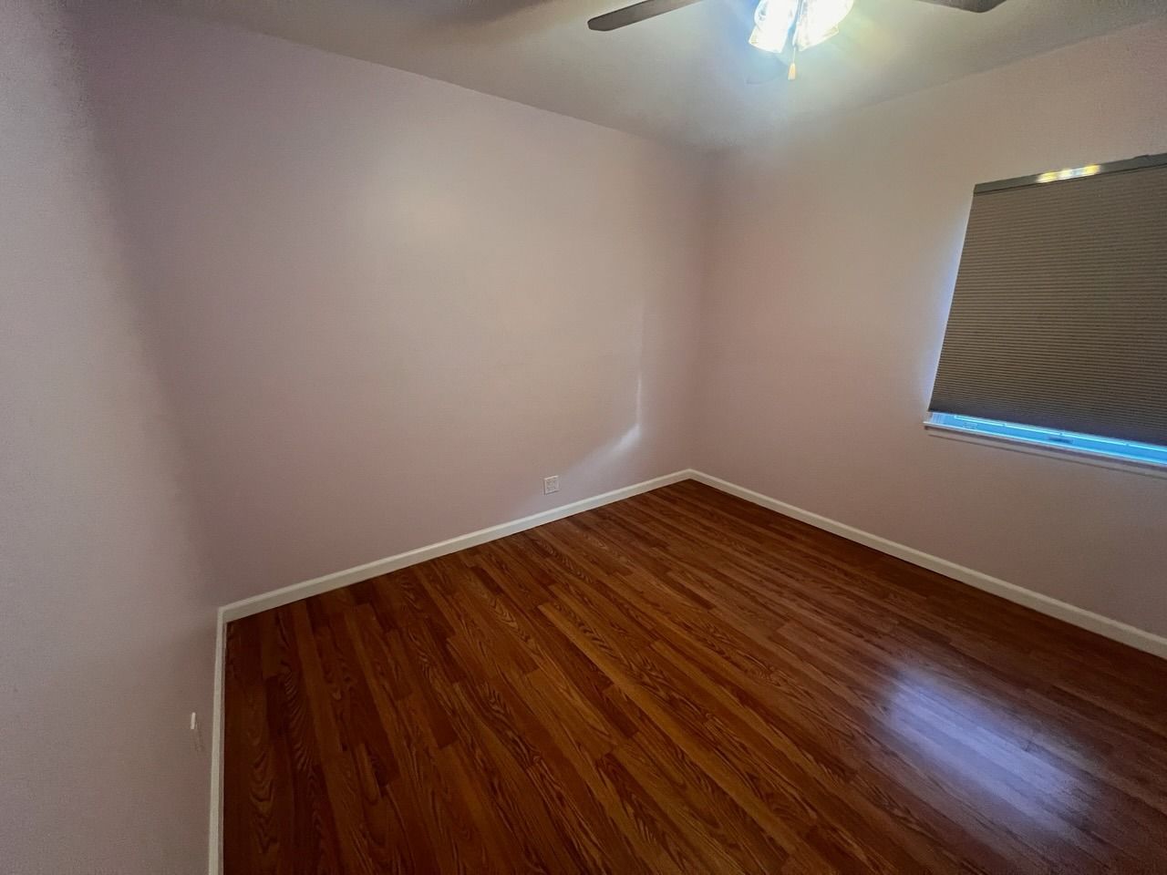 There is a ceiling fan in the room and a window.