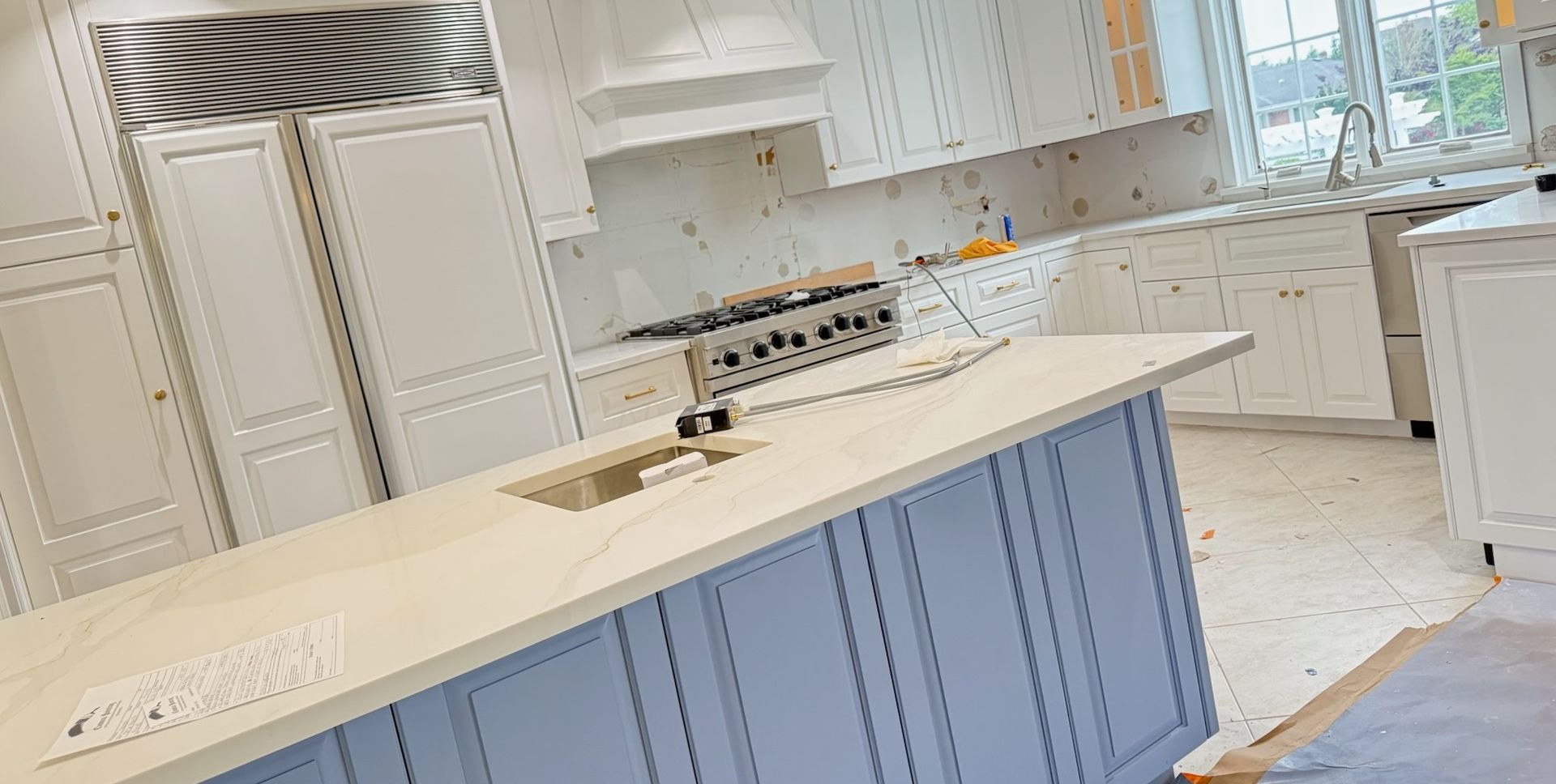 Two kitchen photos: top with white cabinets, bottom with brown cabinets.