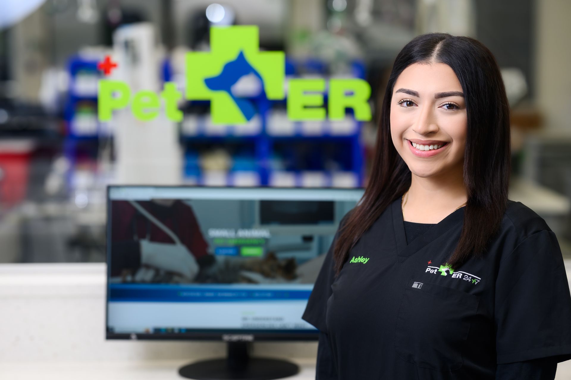 Kennel area with clear glass doors, green accents, and medical equipment; brightly lit.