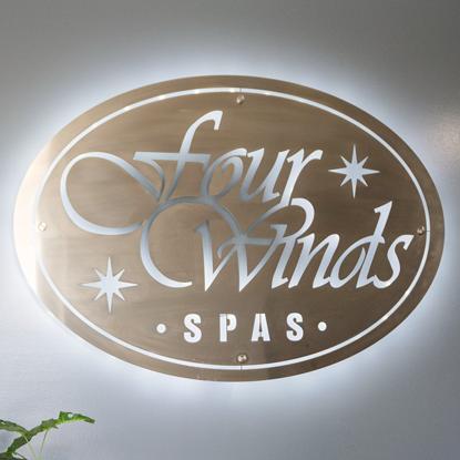 A sign that says four winds spas on it