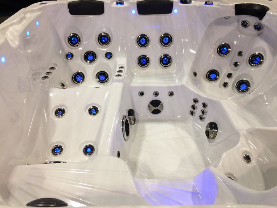 A white hot tub with blue lights on it