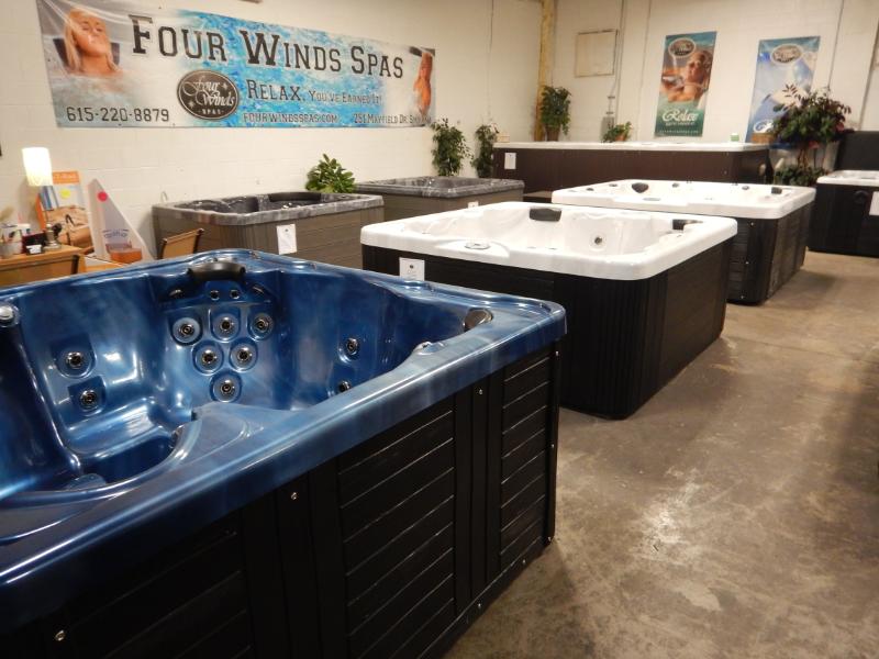 A row of hot tubs in a store called four winds spas