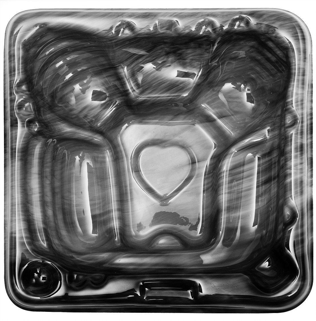 A black and white photo of a hot tub with a heart in the middle.