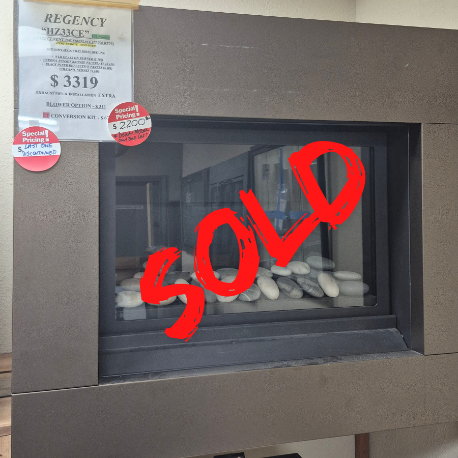 Regency HZ33CE direct vent gas fireplace display model with modern black frame, horizontal firebox, and decorative media bed in Olympia WA