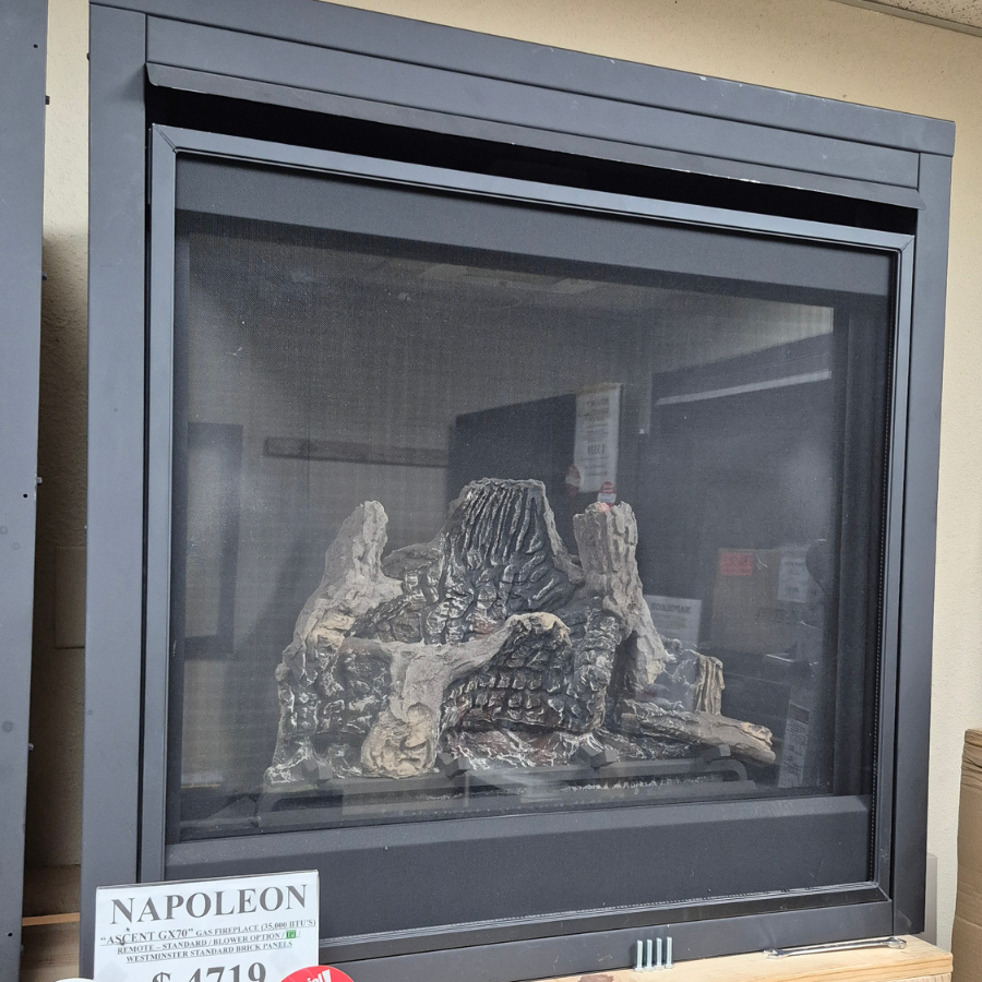 Napoleon Ascent GX70 gas fireplace display model with black surround, large viewing window, and realistic log set in Olympia WA