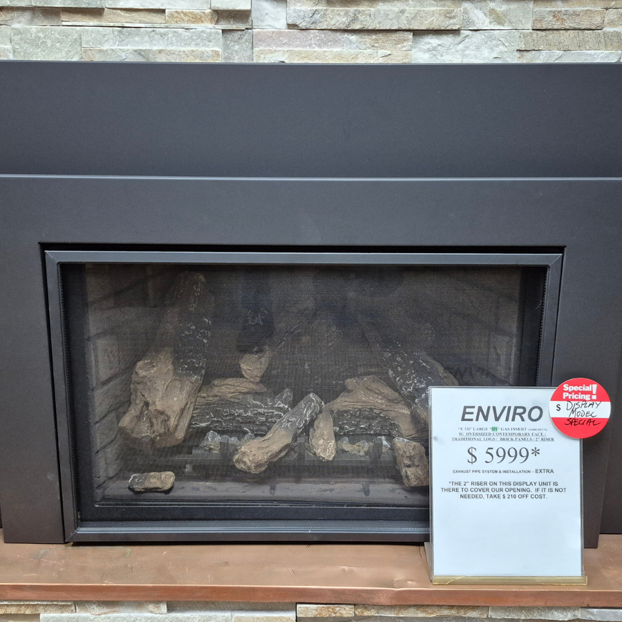 Enviro E33i gas fireplace insert display model with wide black surround, large viewing glass, and traditional log set in Olympia WA