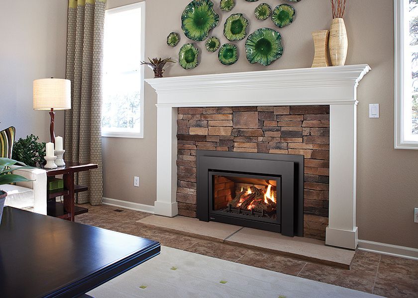 Updated fireplace with modern gas insert providing reliable warmth in Ocean Shores, WA