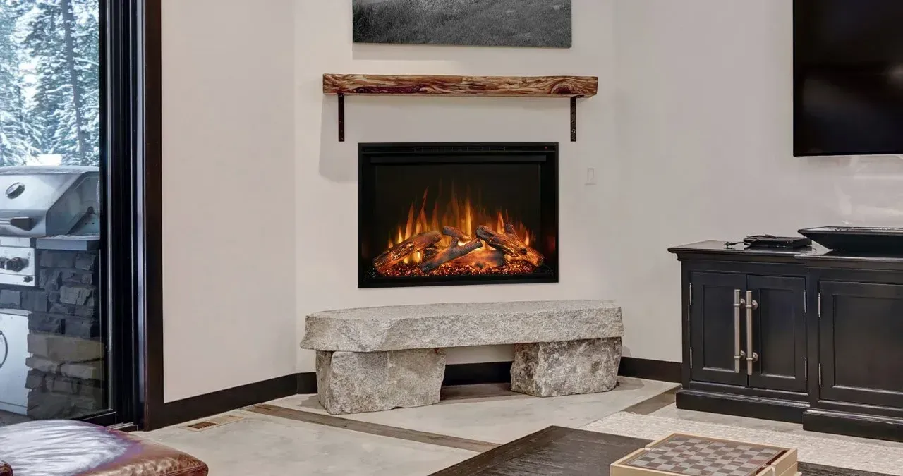 A modern living room with an electric fireplace. A stone bench sits below the fireplace and a wooden shelf above.