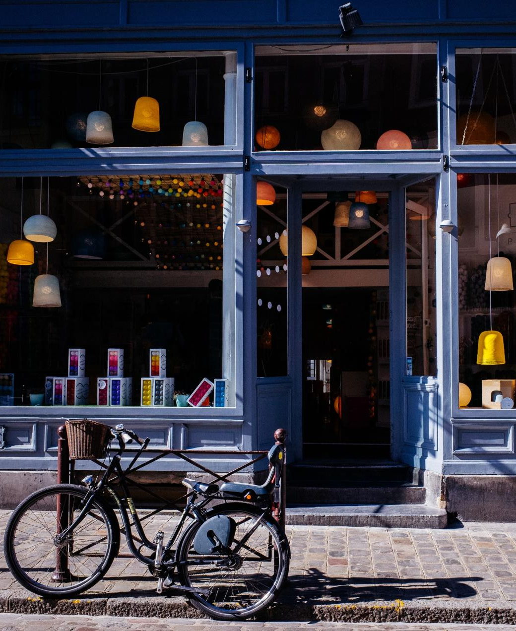 A bicycle is parked in front of a store