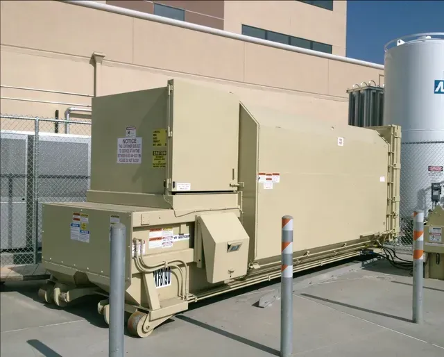 A tall building with a lot of balconies against a blue sky.