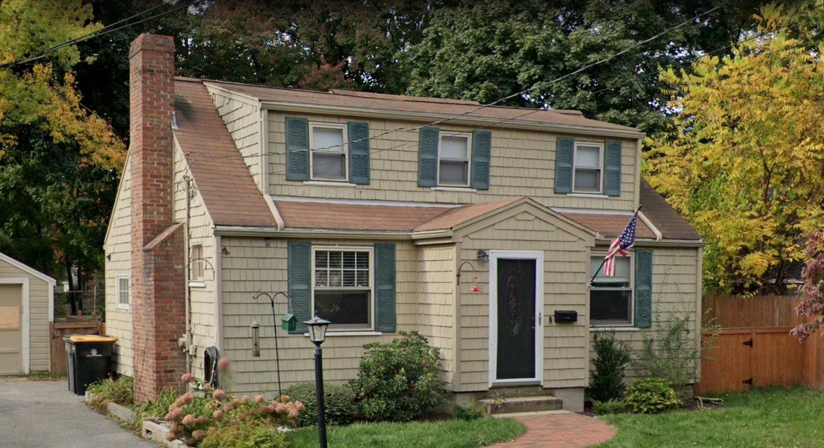 Bruin Remodeling Group | A house with a chimney and a flag on the front of it.