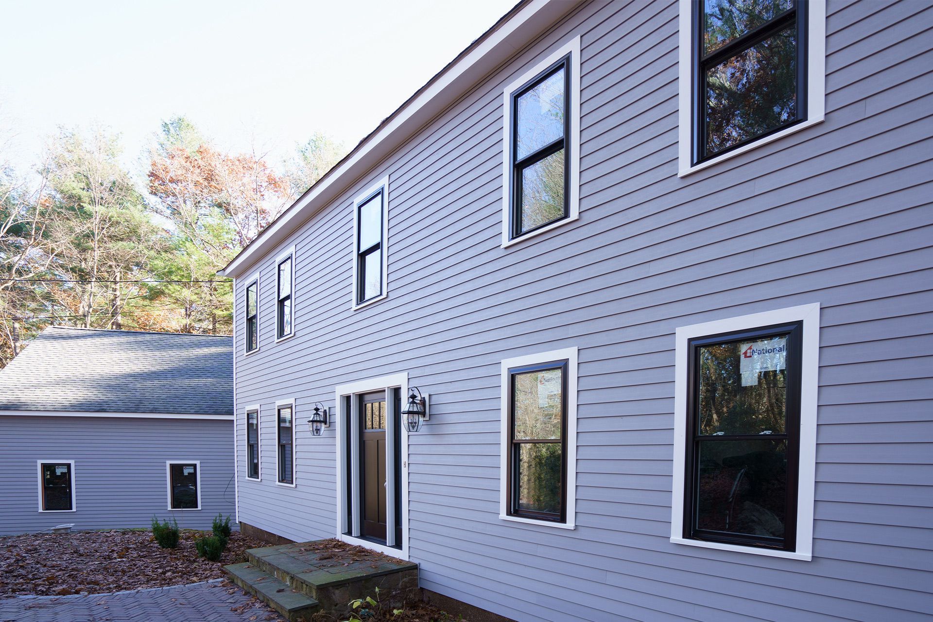 A large house with a lot of windows on the side of it.