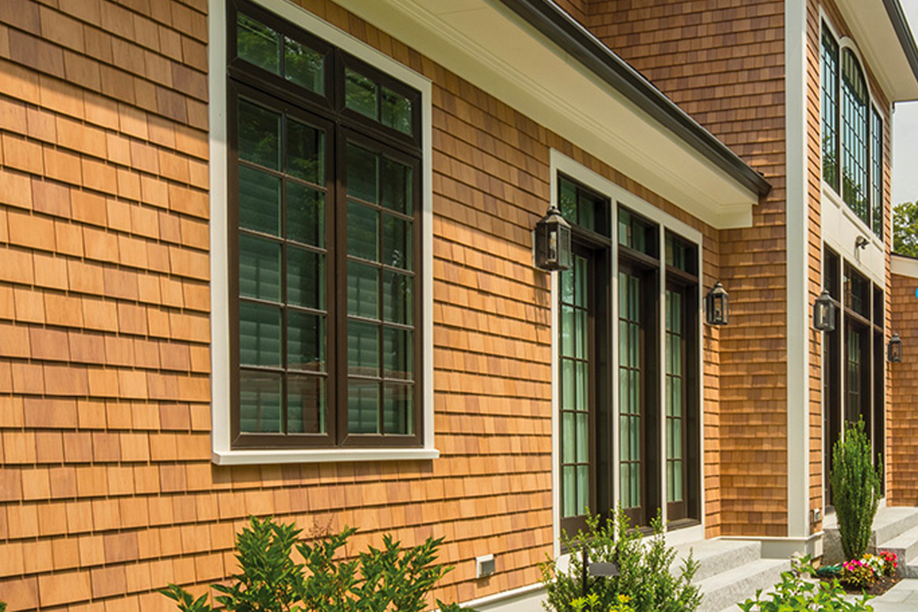 A large brick house with lots of windows and a porch.