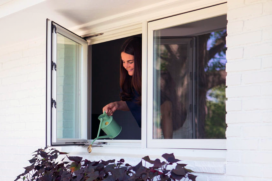 A kitchen with a lot of windows and a stove top oven.