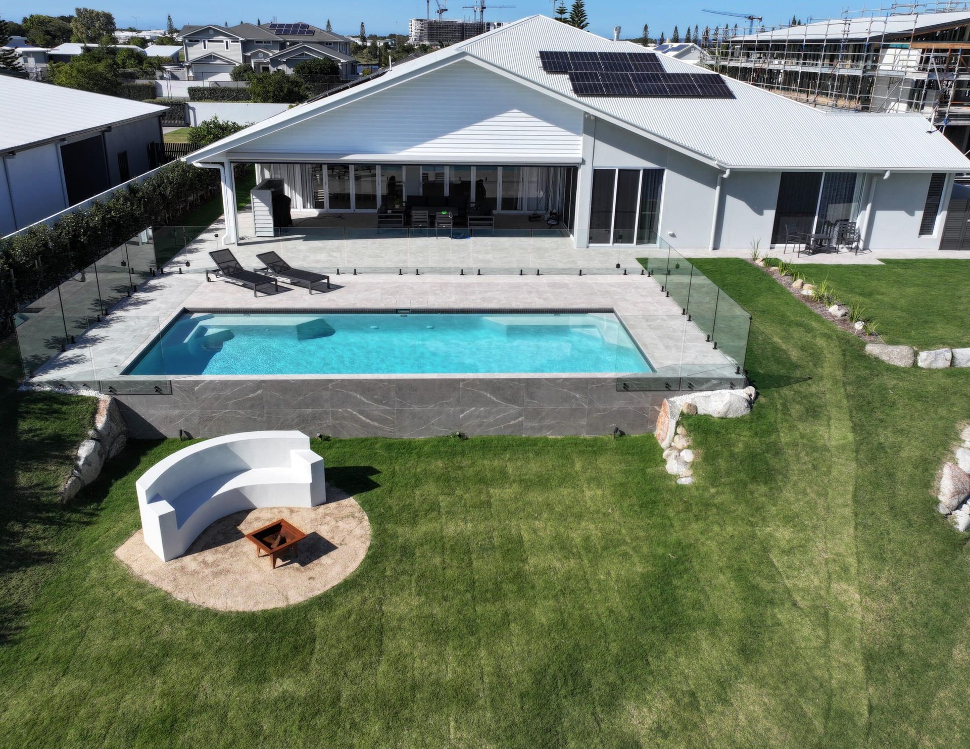 An Aerial View of a House With a Large Swimming Pool — Pools By Design in Warana, QLD