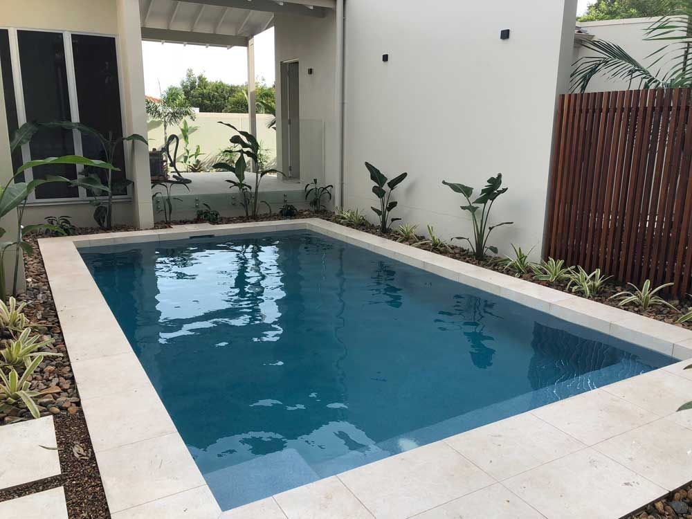 A Small Swimming Pool in the Backyard of a House — Pools By Design in Warana, QLD
