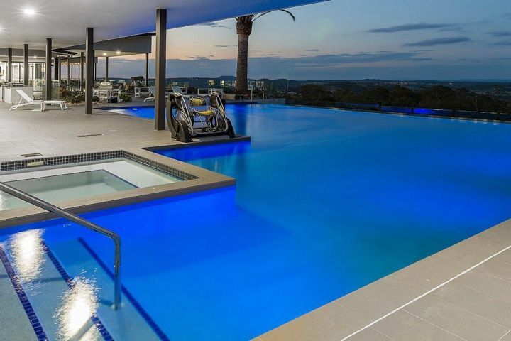 A Large Swimming Pool With Stairs Leading to It — Pools By Design in Warana, QLD