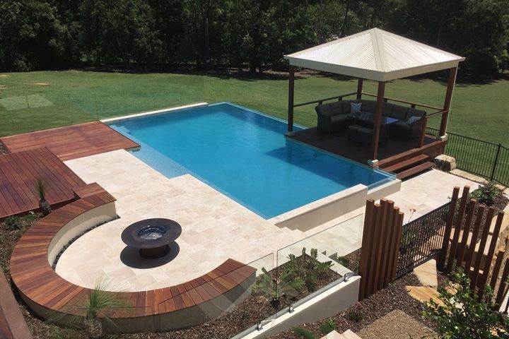 A Large Swimming Pool With a Gazebo in the Backyard — Pools By Design in Warana, QLD