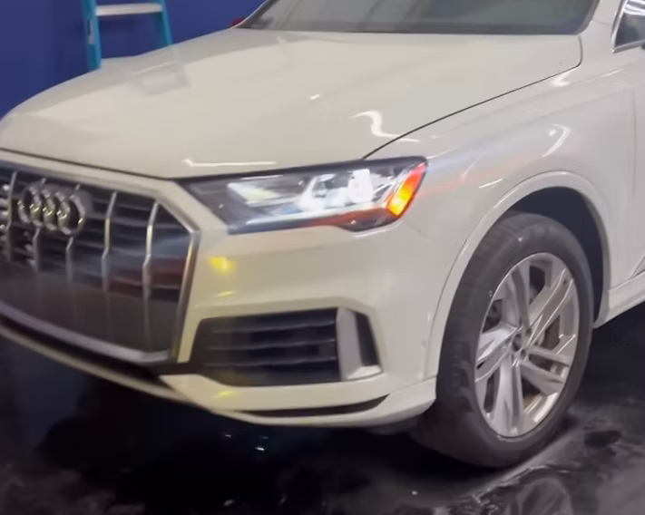 A white audi q7 is parked in a garage | AP Autohouse