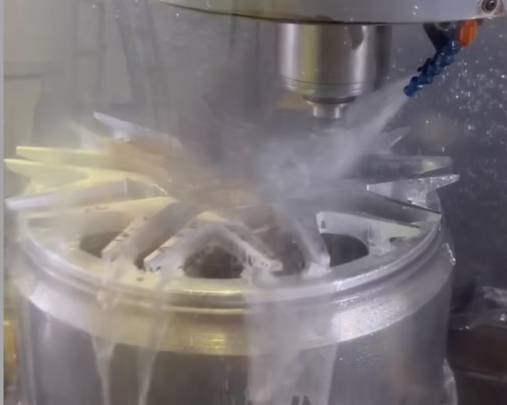 A machine is cutting a wheel with liquid coming out of it | AP Autohouse
