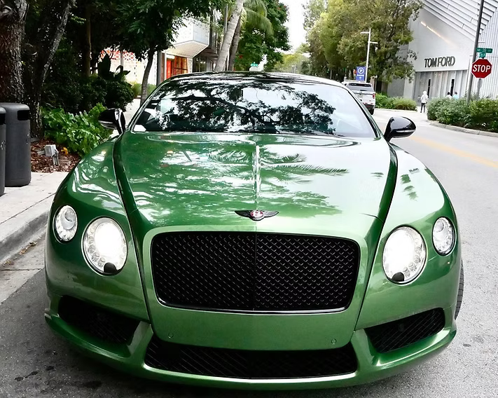A green bentley is parked on the side of the road | AP Autohouse