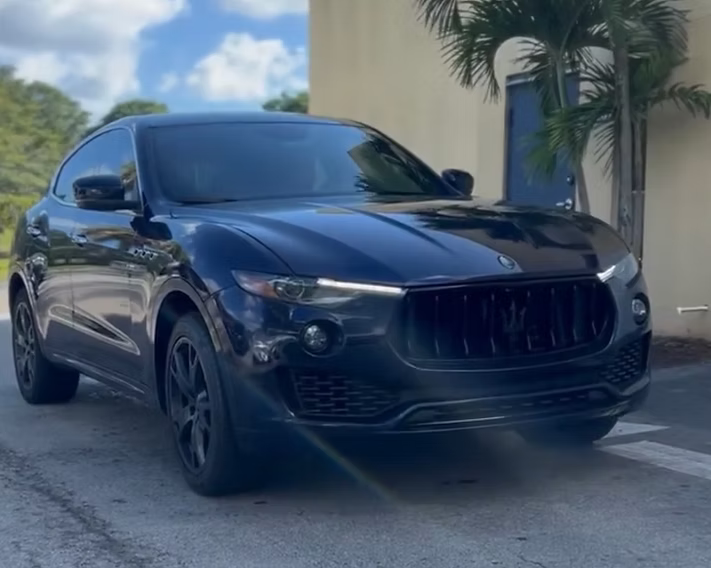 A black car is parked in front of a building | AP Autohouse