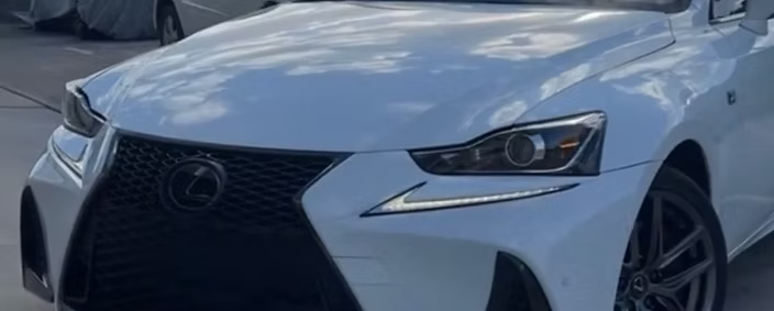 A white lexus is parked in a parking lot | AP Autohouse