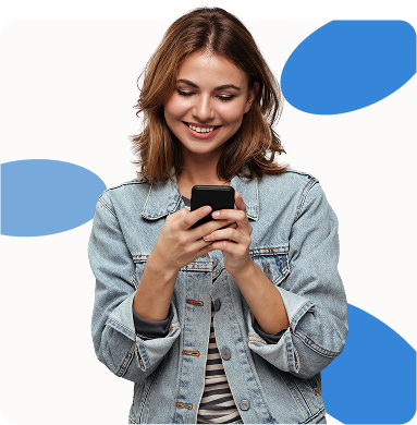 Woman in denim jacket looking at a smartphone, smiling. Light blue shapes in the background.