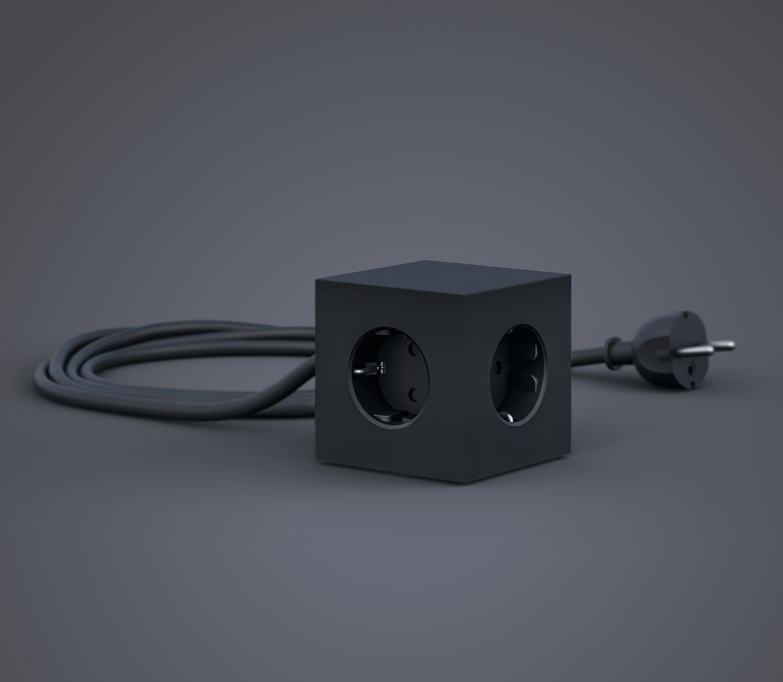Ein schwarzer Würfel mit zwei Steckdosen und einem daran befestigten Kabel