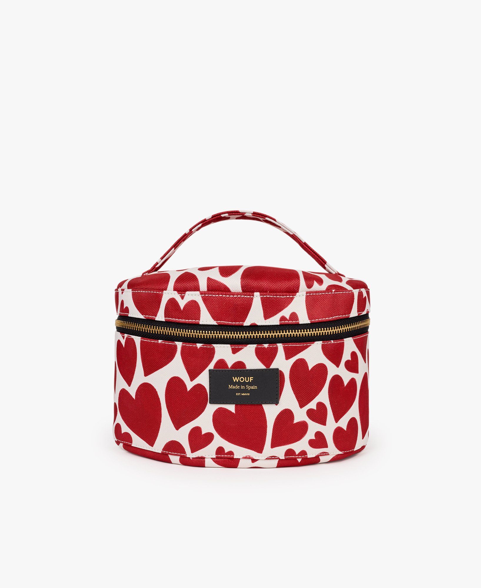 Eine runde Kosmetiktasche mit roten Herzen darauf