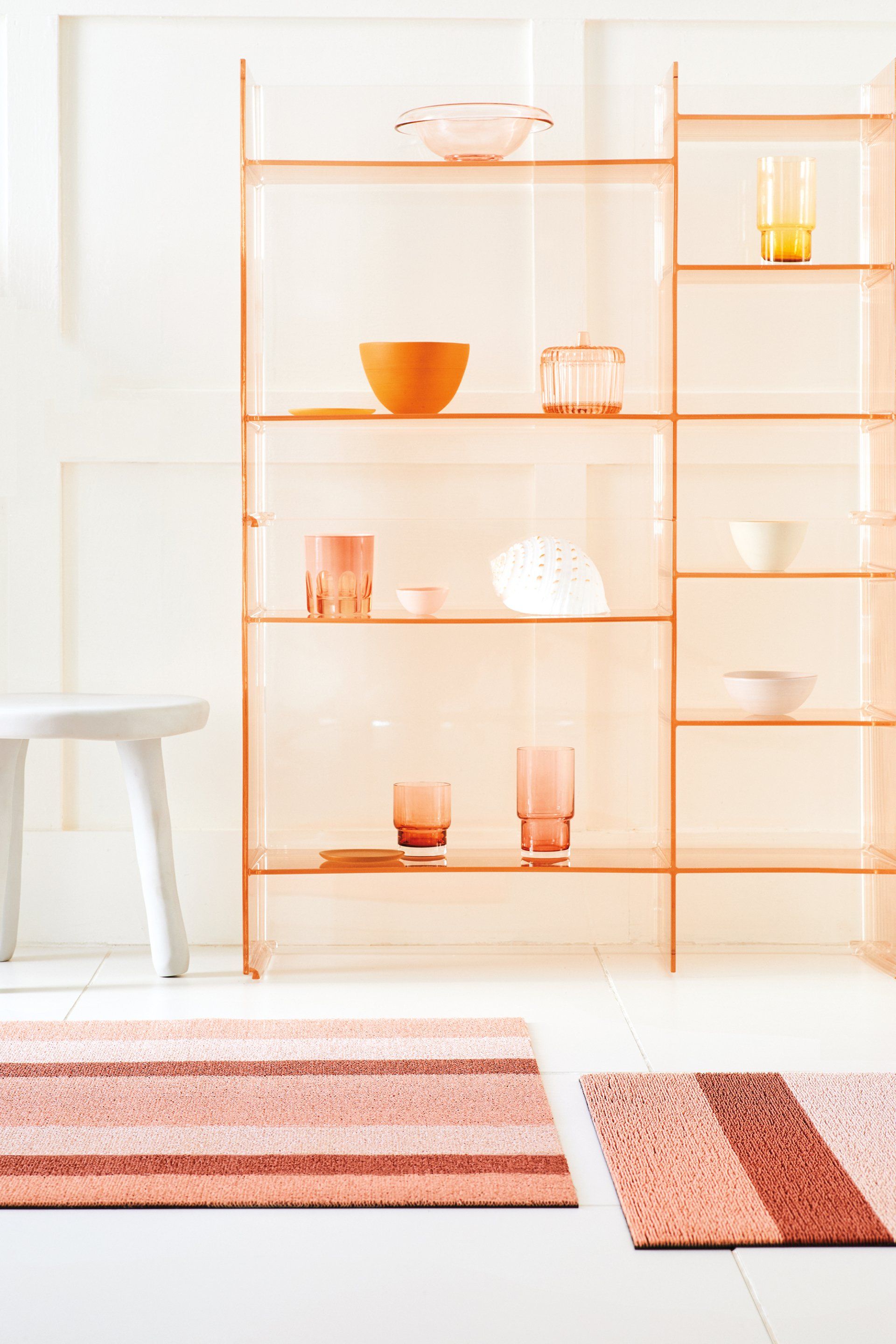 Ein Raum mit einem Regal und einem Teppich auf dem Boden