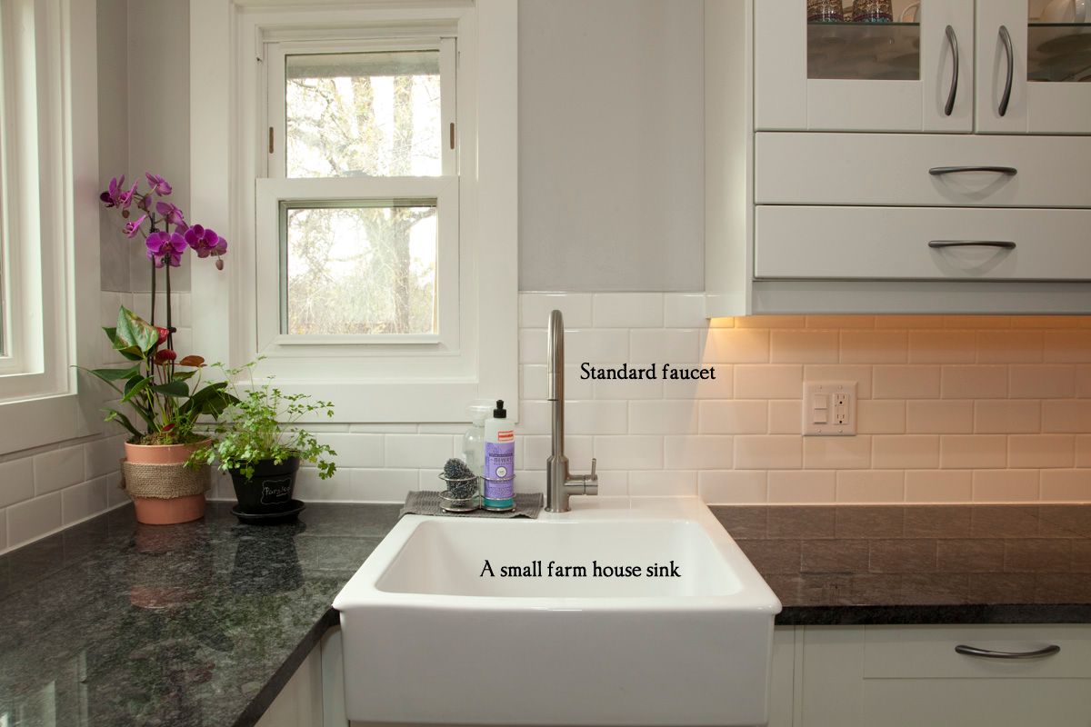 Modern kitchen with wood cabinets, island with stools, and black pendant lights. Modern kitchen with wood cabinets, island with stools, and black pendant lights.
