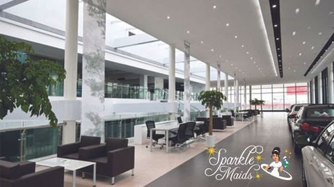 A picture of a car dealership with the words sparkle maids on the bottom